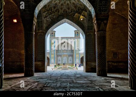 Shiraz, Iran - Mai 2019: Touristes dans la cour de la mosquée Vakil vu de la salle de prière. Vakil signifie régent, titre de Karim Khan, fondateur de Za Banque D'Images