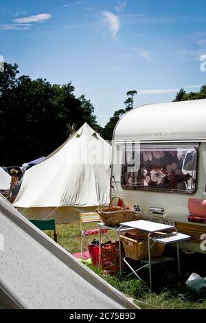 Terrain de camping avec tentes et caravane rétro dans un camping festival, Norfolk Banque D'Images