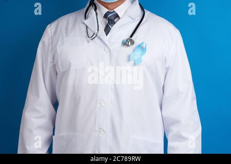 ruban en soie bleu attaché à une couche blanche d'un médic. Sensibilisation au cancer de la prostate. Concept de la Journée mondiale du cancer Banque D'Images
