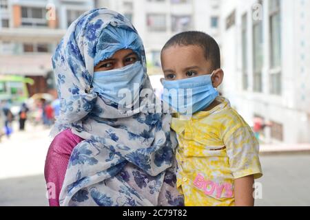 La mère et l'enfant du patient Covid-19 attendent les conseils d'un médecin devant l'hôpital du Dhaka Medical College pendant la pandémie du coronavirus à Dhaka, Bangl Banque D'Images