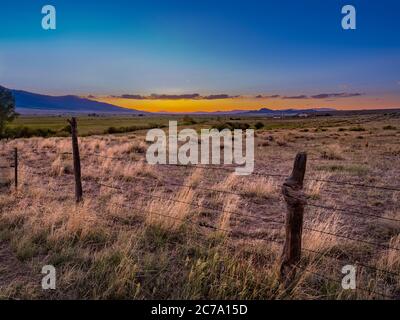 Ancienne clôture barbelée au coucher du soleil, Westcliffe, Colorado, États-Unis Banque D'Images