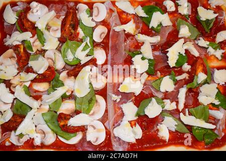 La pizza italienne est dotée d'une base plate ronde de pâte à base de blé levain, recouverte de jambon aux champignons au fromage cuit à haute température dans un four à bois Banque D'Images