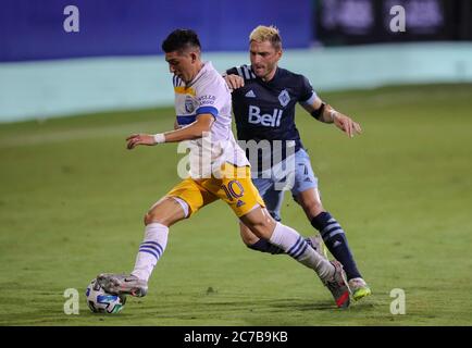 Orlando, Floride, États-Unis. 15 juillet 2020: San Jose tremblements de terre en avant CRISTIAN ESPINOZA (10) concurrence pour le ballon contre Vancouver Whitecaps milieu de terrain DAVID MILINKOVIC (7) pendant le tournoi MLS est de retour San Jose tremblements de terre contre Vancouver Whitecaps match au complexe ESPN Wide World of Sports à Orlando, FL le 15 juillet 2020. Crédit : Cory Knowlton/ZUMA Wire/Alay Live News Banque D'Images