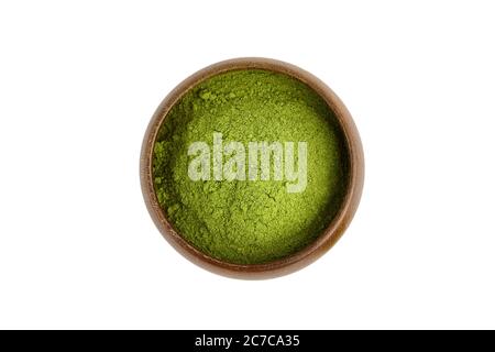 Blé vert lyophilisé ou poudre d'orge dans un bol en bois isolé sur fond blanc, vue du dessus. Banque D'Images