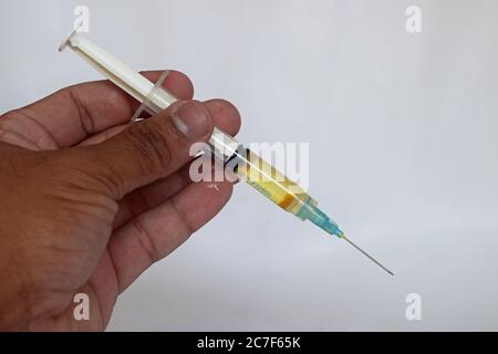 Seringue, injection médicale dans la main, paume ou doigts. Matériel de vaccination en plastique médical avec aiguille. Infirmière ou médecin. Drogue liquide ou narcotique. Banque D'Images