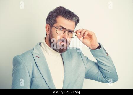 Beau jeune homme portant un costume avec des lunettes. Banque D'Images