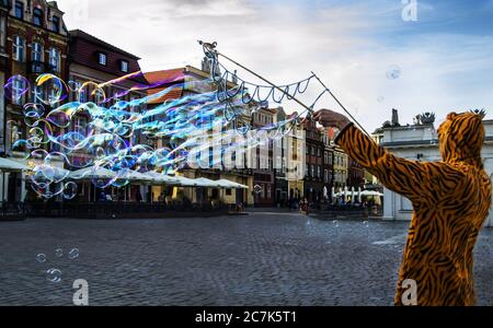 Personne portant un costume de tigre faisant des bulles dans la rue à Poznan, en Polonia Banque D'Images