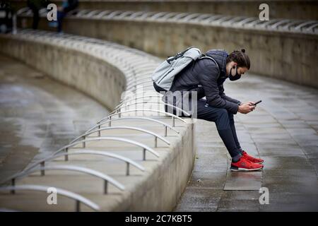 Manchester Exchange Square un jeune homme portant un masque de protection Banque D'Images