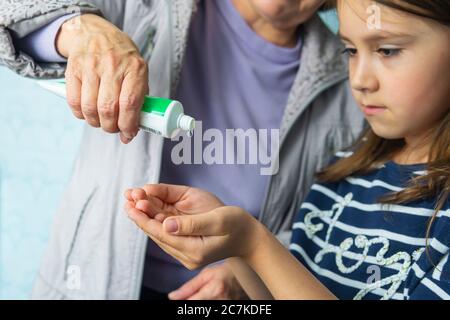Enfant fille utilisant l'alcool antiseptique gel, prévention, nettoyage des mains fréquemment, prévenir l'infection, épidémie de Covid-19 , fille se laver les mains avec main sa Banque D'Images