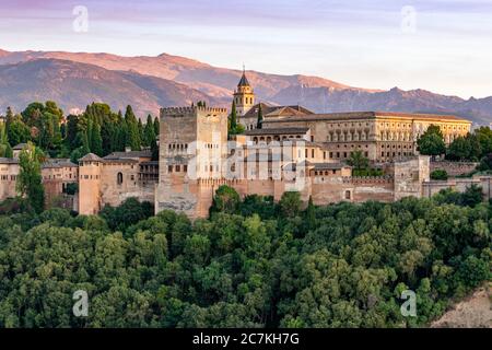 Perché au-dessus de la Valle Del Darro, le soleil du soir illumine l'Alhambra spectaculaire de Grenade, avec la Sierra Nevada au loin. Banque D'Images