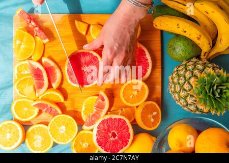 Tranches de pamplemousse et d'orange fraîchement coupées avec fond en bois bleu . Banque D'Images