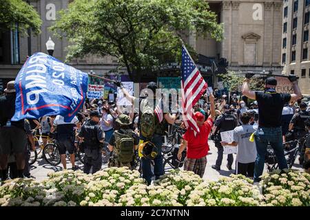 Columbus, États-Unis. 18 juillet 2020. Les partisans de Trump brandit des drapeaux lors d'un rassemblement « anti-masque » à l'Ohio Statehouse.plus de 200 personnes se sont rassemblées à l'Ohio State House pour protester contre le mandat de masque facial que de nombreux comtés sont sous le gouvernement. Crédit : SOPA Images Limited/Alamy Live News Banque D'Images