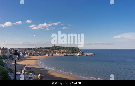 Vue sur South Bay, Scarborough. La plage se courbe autour de la rive et les bâtiments de la ville sont pris dans la lumière du soir. Le spa Scarborough est Banque D'Images