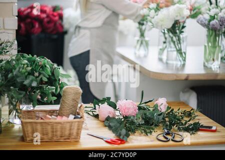 Florist workplace with summer flowers and accessories Stock Photo