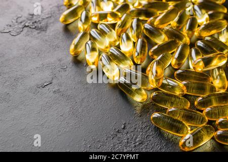 capsules d'huile de poisson sur fond noir avec espace pour le texte Banque D'Images