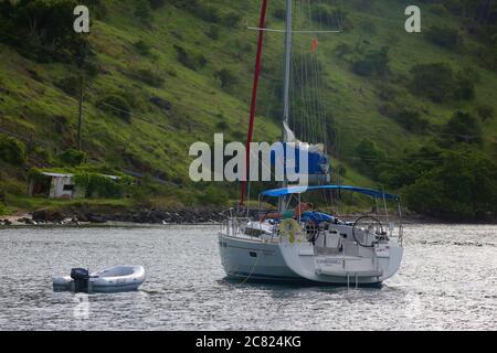 Un homme fait des retouches sur le pont d'un voilier amarré au large de la côte de l'île Jost Van Dyke dans les îles Vierges britanniques le 31 juillet 2017. Banque D'Images