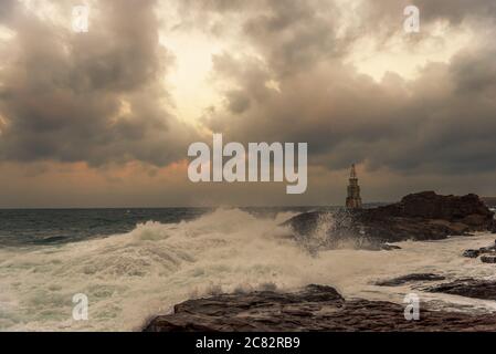 Jour nuageux orageux. Ciel dramatique et des vagues énormes au phare, Ahtopol, Bulgarie. Banque D'Images