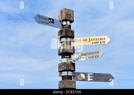 Un panneau directionnel en bois à Cape point, Cape Town, Afrique du Sud, indique Londres, Sydney, Rio et Amsterdam. Banque D'Images