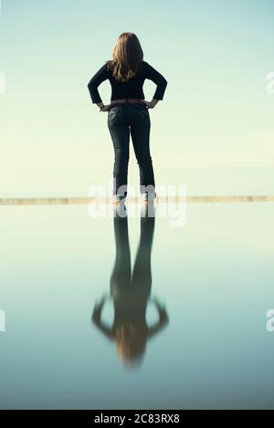 Vue arrière de la femme avec réflexion sur l'eau Banque D'Images