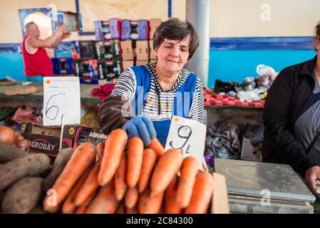 Chisinau / Moldova - 15 mai 2020 : une femme moldave vend des légumes et des légumes verts sur le marché agricole local Banque D'Images