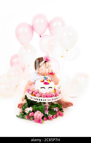 Portrait vertical de style de vie d'une petite fille ayant un gâteau smash pour célébrer son premier anniversaire. Banque D'Images