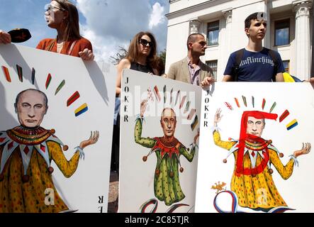 Les activistes détiennent des cartes à jouer symboliques de grande taille dépeintes président de la Russie, Vladimir Poutine, lorsqu'ils prennent part à un rassemblement de performance « la maison de cartes de Poutine », devant la Verkhovna Rada (Parlement ukrainien). La représentation a été tenue par d'anciens prisonniers ukrainiens du conflit de l'est de l'Ukraine, des parents, Des militants des droits de l'homme et des artistes comme l'artiste Donetsk, Serhiy Zakharov, pour attirer l'attention des législateurs sur le problème de l'impunité pour les crimes de guerre. Les militants protestent contre les autorités russes. Banque D'Images