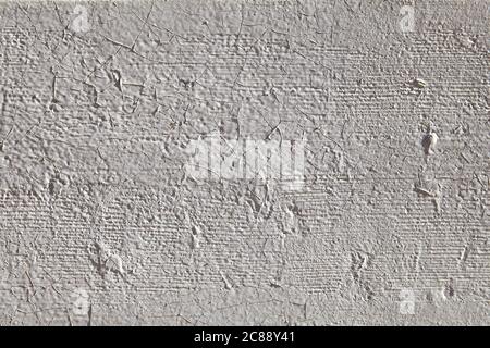 Texture grise du plâtre peint avec gouttes de peinture, fissures, irrégularités. Banque D'Images