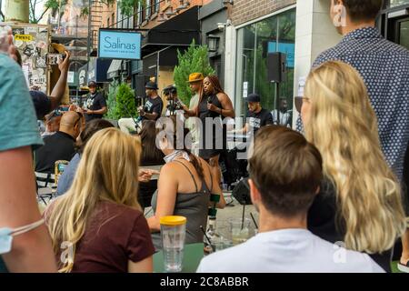 La foule se rassemble à l'extérieur de la baignoire Gin dans le quartier de Chelsea, à New York, tandis que le bar célèbre son 9e anniversaire avec une fête le jeudi 16 juillet 2020. Gov. NYS Andrew Cuomo annoncera des plans pour que la ville entre dans la phase 4 de sa réouverture, mais aucune activité intérieure supplémentaire ne sera autorisée, citant partiellement les problèmes de non-conformité des bars et des restaurants. (© Richard B. Levine) Banque D'Images