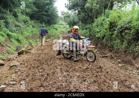 Nakuru, Kenya. 18 juillet 2020. Un habitant de Marioshoni lutte pour conduire sa moto sur une route boueuse.le gouvernement du Kenya expulse avec force des gens qui se seraient installés sur des terres forestières gazées pour ouvrir la voie au reboisement. Des plaintes généralisées ont été déposées sur la façon dont le gouvernement traite la question. Les organisations de droits de l'homme ont dénoncé la force brute exercée sur les personnes qui résidaient prétendument sur les terres forestières, essentiellement des pauvres, terrant l'exercice injuste et illégal. Crédit : James Wakibia/SOPA Images/ZUMA Wire/Alay Live News Banque D'Images