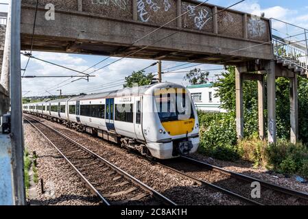 Train C2C traversant la zone du chemin Crowstone de Westcliff on Sea, Southend, Essex, Royaume-Uni. Chemin de fer électrifié dans la zone urbaine. Passerelle Graffiti Banque D'Images