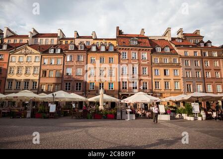 Varsovie / Pologne - 10 juin 2019 : terrasses de restaurants dans le centre de Varsovie pendant les heures d'or du coucher du soleil avec des bâtiments colorés d'architecture traditionnelle Banque D'Images