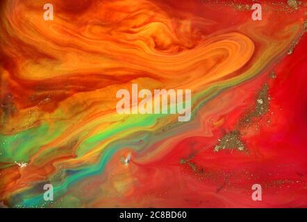 Motif fluide rouge et orange avec de petites particules d'or Banque D'Images
