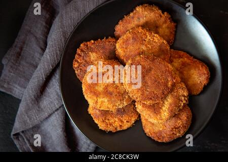 Patties ou côtelettes de légumes pour hamburgers végétaliens sur une assiette noire. Vue de dessus. Banque D'Images