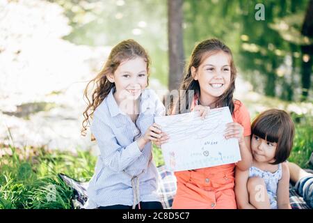 groupe de petites filles et de garçons peinture avec pinceau et peintures colorées Banque D'Images