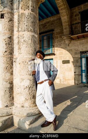 La Havane / Cuba - 04.16.2015: Afro cuban vieux avec une longue barbe blanche portant un costume et un béret militaire noir, fume un gros cigare Banque D'Images