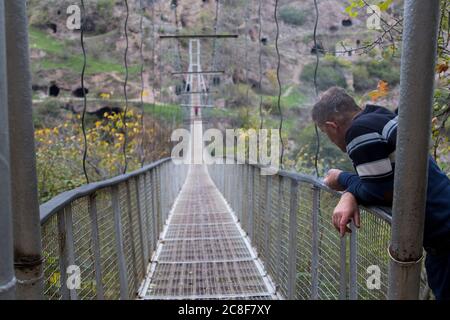 Le village troglodyte de Khndzoresk est relié par un pont suspendu de 160 m de long et de 36 m de haut. Le village est dans le sud-est de l'Arménie. Banque D'Images