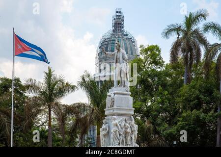 La Havane / Cuba - 04.15.2015: La statue en marbre blanc du célèbre poète José Marti face au drapeau national de Cuba, des oiseaux sur sa main et sa tête. Derrière Banque D'Images