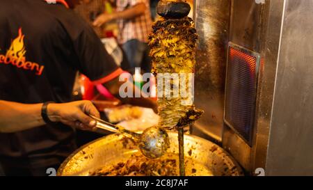 Poulet grillé dans une brochette rotative pour servir un aliment du Moyen-Orient appelé Shawarma Banque D'Images