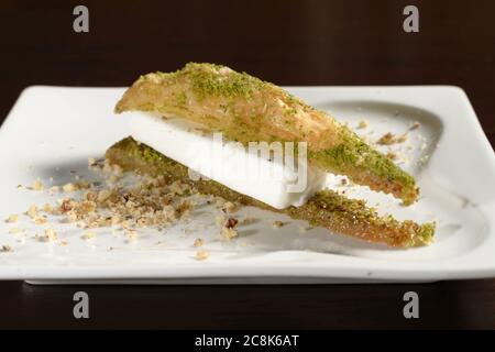 Baklava turque triangulaire avec glace sur une assiette de près. Photos pour les menus du restaurant et du café Banque D'Images