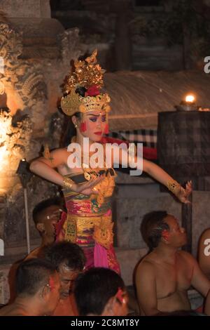 Photo dramatique de danseurs Kecak vêtus de couleurs vives et habillés de costumes traditionnels, qui exécutent la danse du temple hindou de Ramayana balinais. Banque D'Images