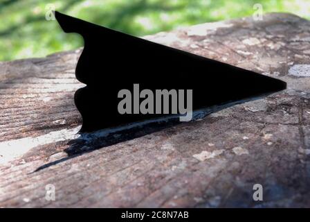 Gros plan d'un gnomon d'un cadran solaire sur un ancienne surface métallique rouillée Banque D'Images