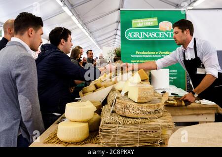 BRA, ITALIE - 18 SEPTEMBRE 2017 : fromage dur traditionnel sur un marché à Bra (Italie), le 18 septembre 2017, avec un cheesmaller et des clients Banque D'Images