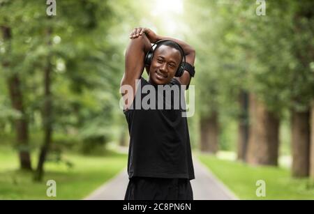 Sportif noir souriant qui s'amusent au parc Banque D'Images