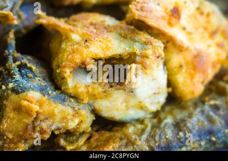 Morceaux de poisson navaga en pâte, frits dans l'huile dans une casserole. Banque D'Images