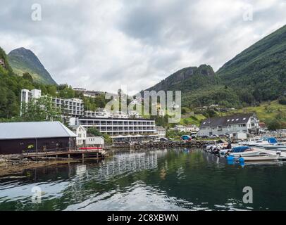 Geiranger, Norvège, 7 septembre 2019: Vue sur le port du village touristique de Geiranger avec de petits bateaux, hôtel et quai de port. Geirangerfjord avec des falaises vertes Banque D'Images