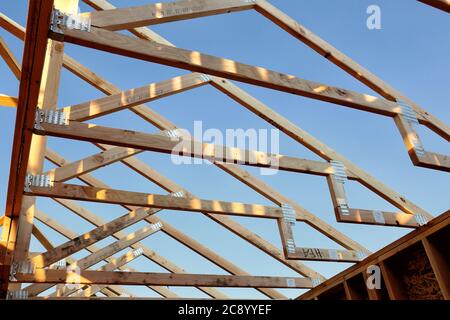 Une vue ouverte sur les fermes de toit en bois sur une maison en construction. Banque D'Images