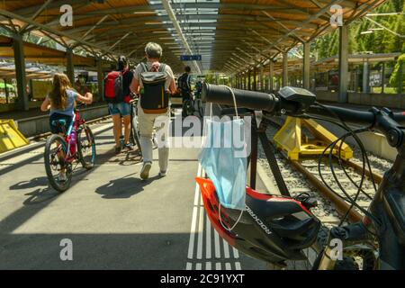 Zermatt, Suisse - 20 juillet 2020 : masque suspendu au guidon d'un vélo dans une gare Banque D'Images