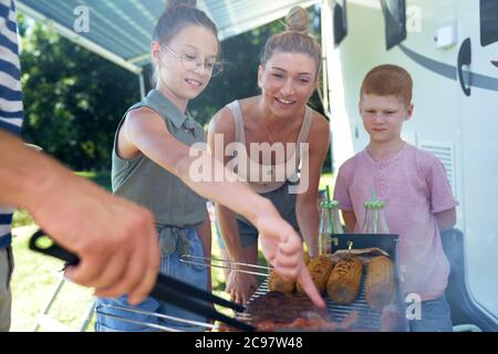 Famille attendant les repas du barbecue Banque D'Images