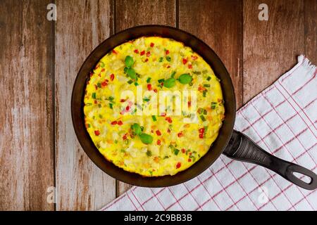 Frittata au fromage, chou-fleur, poivron vert et rouge dans une poêle à frire. Banque D'Images