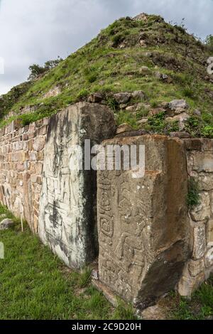 Pierres sculptées montrant des figures sur les coins de la plate-forme Sud dans les ruines de Zapotec pré-colombiennes de Monte Alban à Oaxaca, Mexique. Un ver de l'UNESCO Banque D'Images